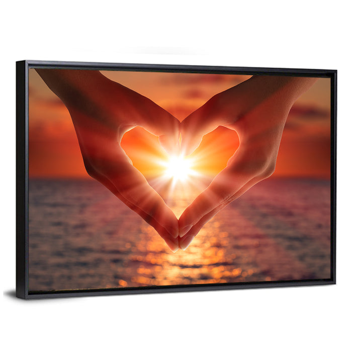 Hands Forming Heart at Sunset Wall Art as a framed canvas
