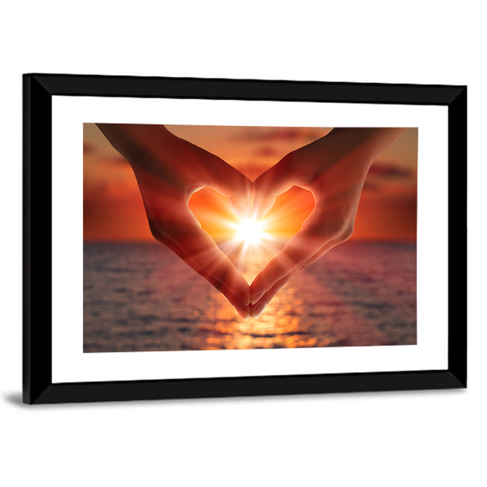 Hands Forming Heart at Sunset Wall Art as a framed print
