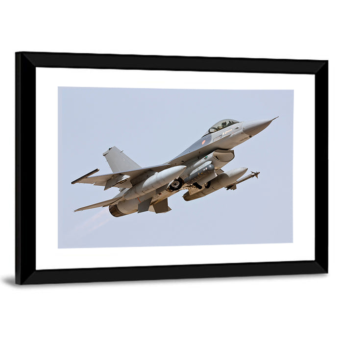 F-16 Fighter Jet Banking Over Sky Wall Art as a framed print