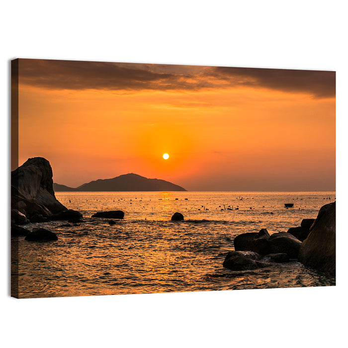 Orange Sunrise Over Rocky Coast Wall Art as a canvas print