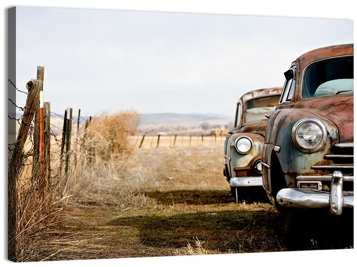 Abandoned Rusty Vintage Cars Behind Barbed Wire Wall Art as a canvas print