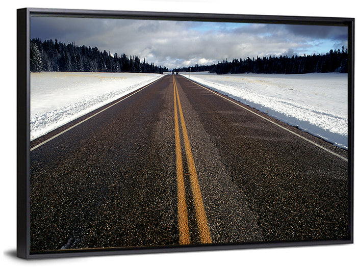 Winter Road Through Pine Forest Wall Art as a framed canvas