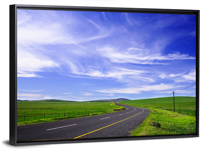 Winding Country Road in Green Fields Wall Art as a framed canvas