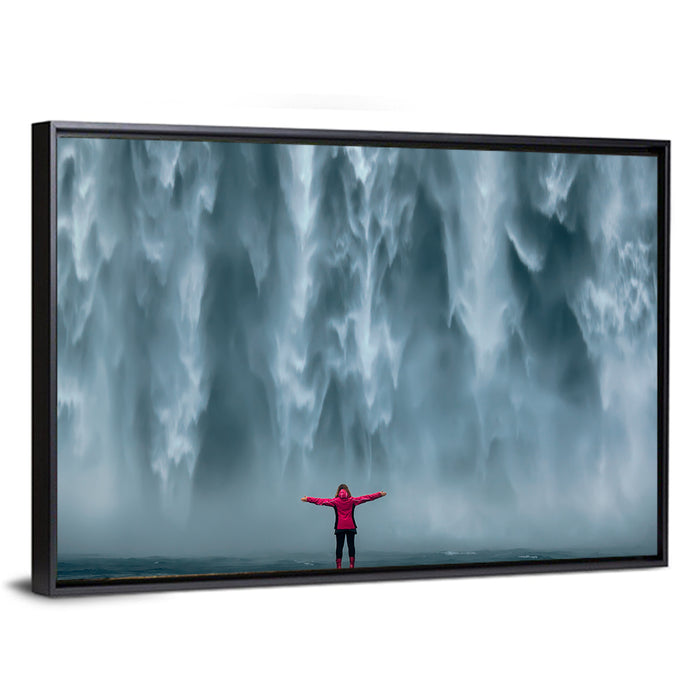 Skogafoss Waterfall with Figure in Pink Wall Art as a framed canvas