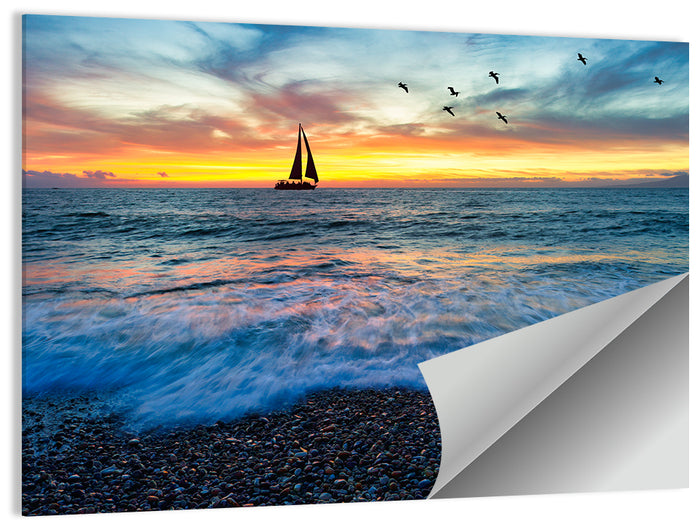 Sunset Sailboat Over Pebble Shore Wall Art as a poster print