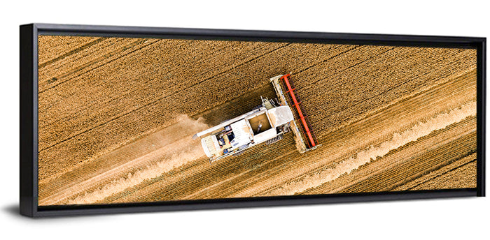 Aerial Combine Over Wheat Field Wall Art as a framed canvas