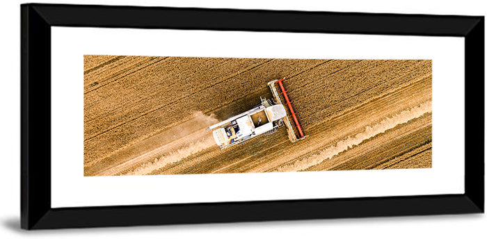 Aerial Combine Over Wheat Field Wall Art as a framed print
