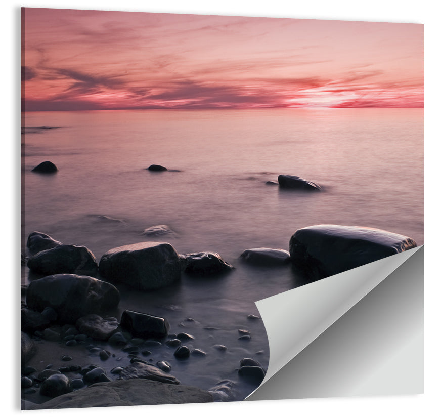 Pink Dusk Lakeshore with Silhouetted Rocks Wall Art