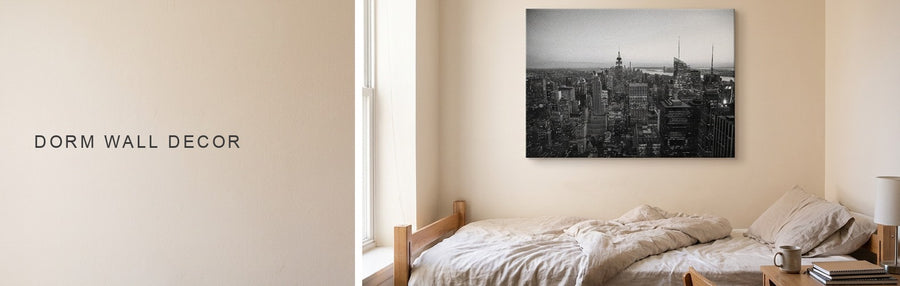 Dorm wall decor above a twin bed and small desk: a black and white New York skyline print in a shared room