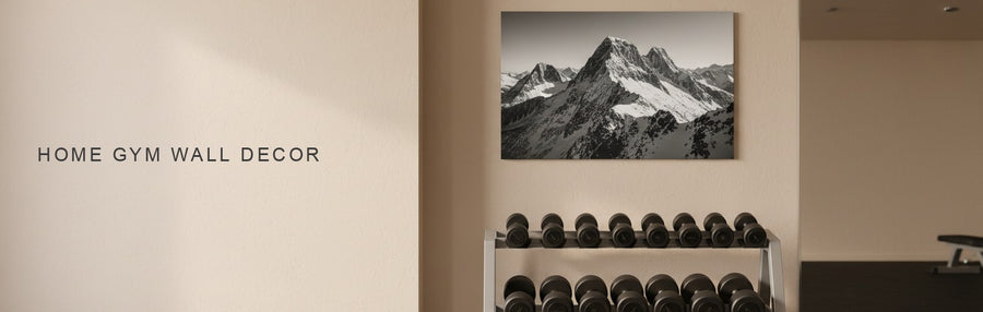 Home gym wall decor in a gym with rubber flooring, a dumbbell rack and a mirror: a black and white mountain summit canvas