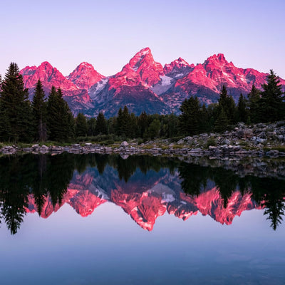 National park wall art, the Grand Teton range reflected in a still lake at sunrise with pink alpenglow