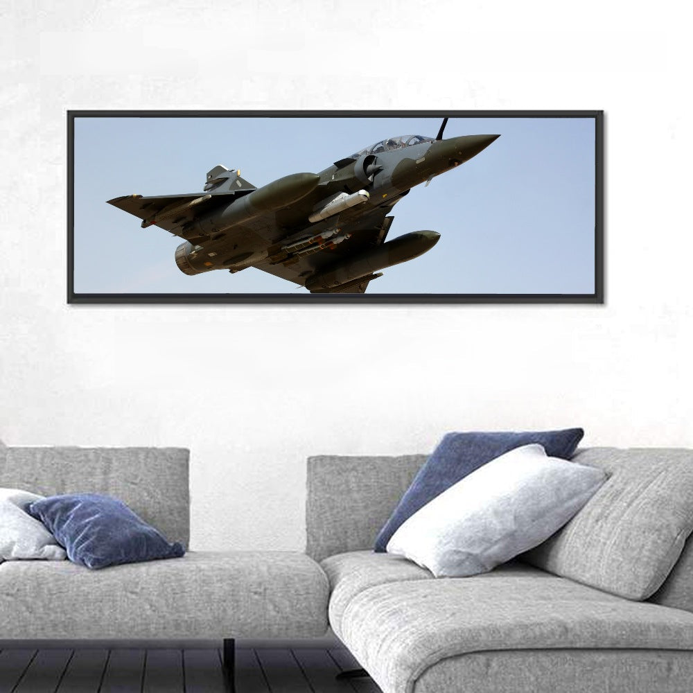 Camouflaged Fighter Jet in Flight Wall Art in a room, panoramic