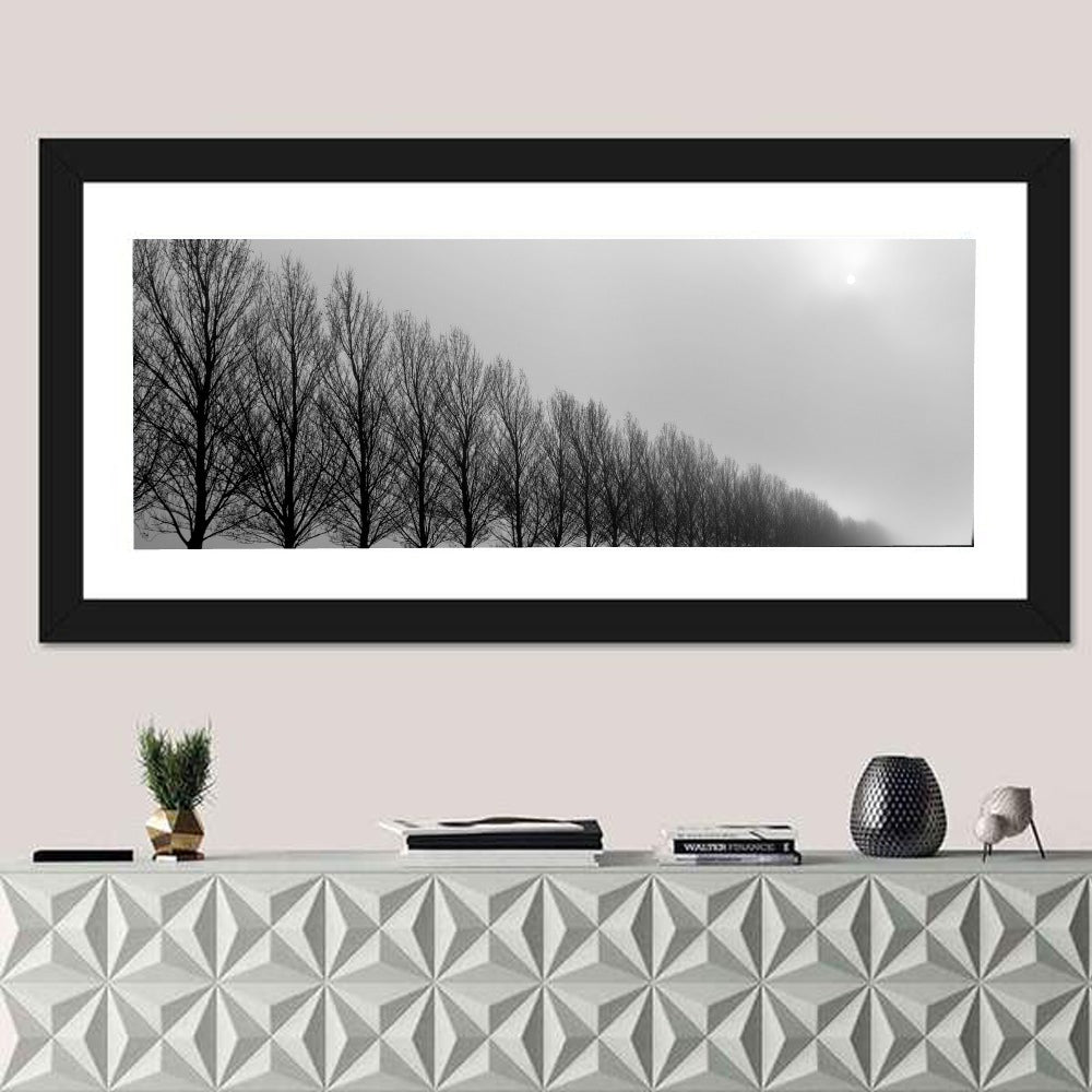 Misty Row of Bare Trees Wall Art in a room, panoramic