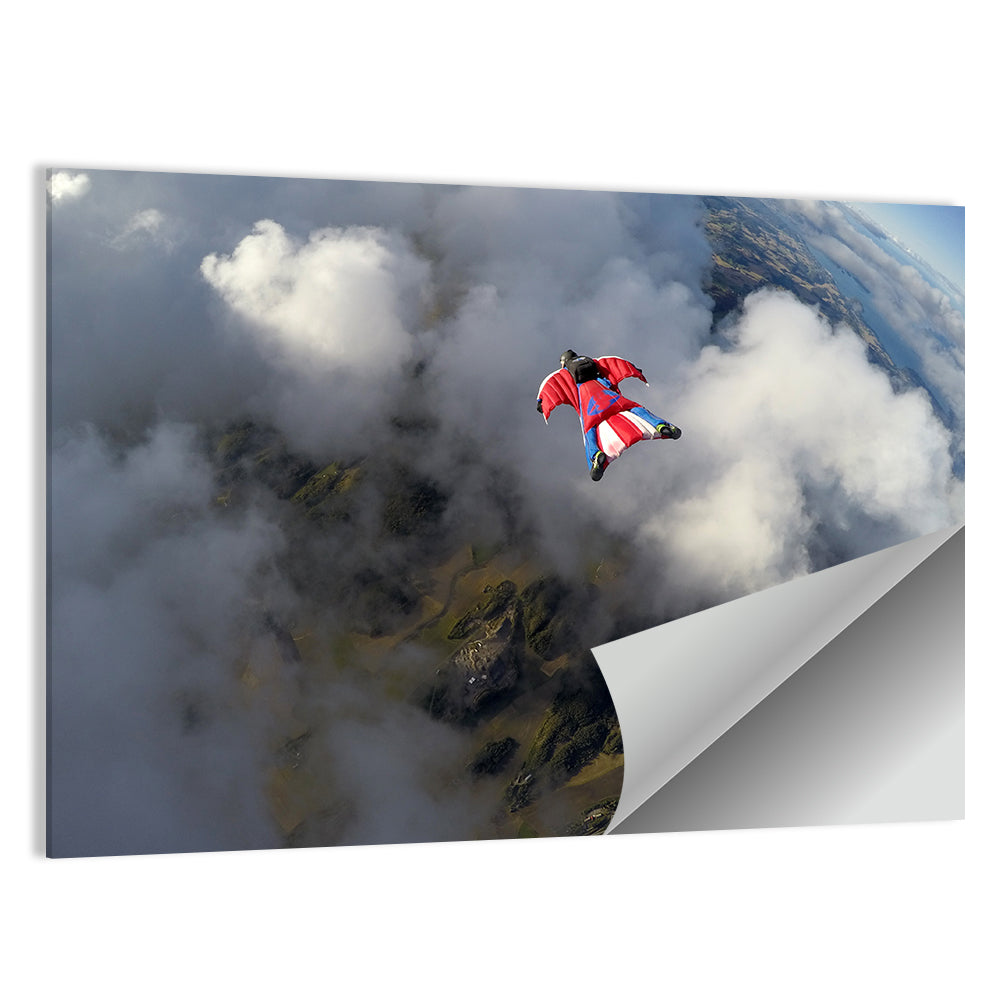 Red Wingsuit Skydiver Over Clouds Wall Art