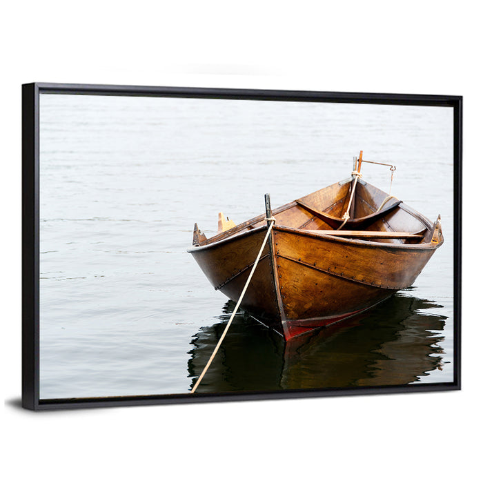 Tethered Wooden Rowboat on Calm Water Wall Art as a framed canvas