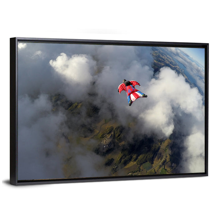 Red Wingsuit Skydiver Over Clouds Wall Art as a framed canvas