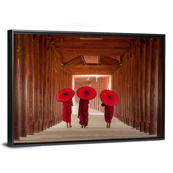 Novice Monks with Red Umbrellas Wall Art as a framed canvas