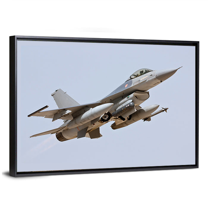 F-16 Fighter Jet Banking Over Sky Wall Art as a framed canvas