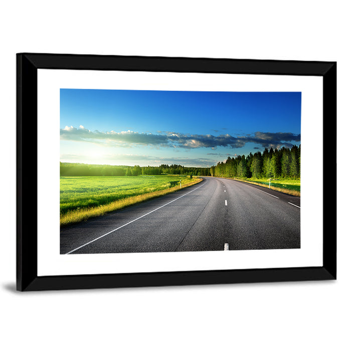 Curved Asphalt Road Through Forest Wall Art as a framed print