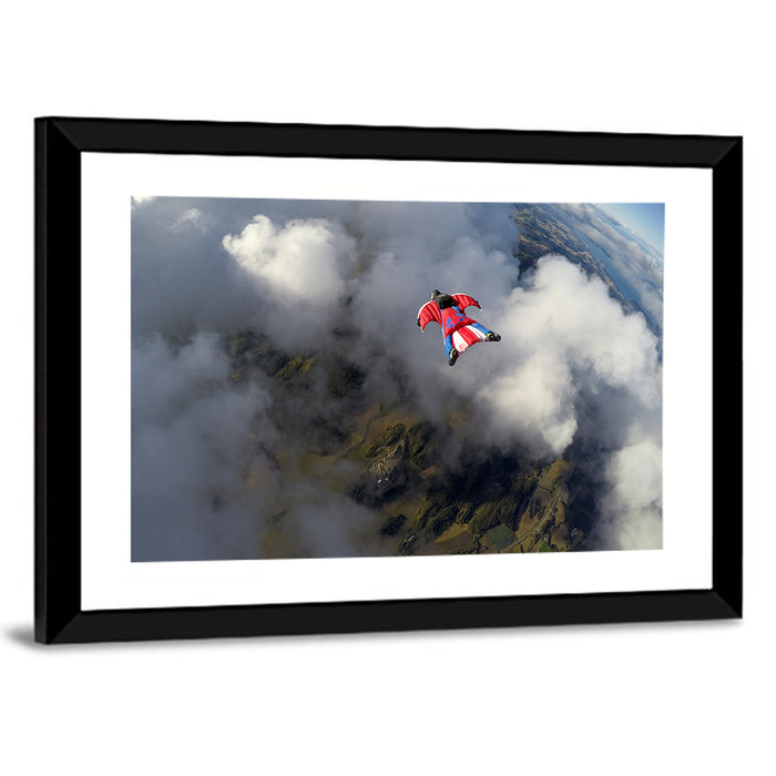 Red Wingsuit Skydiver Over Clouds Wall Art as a framed print