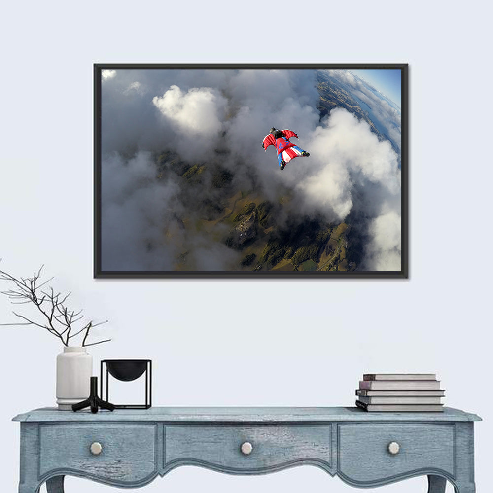 Red Wingsuit Skydiver Over Clouds Wall Art in a room, landscape