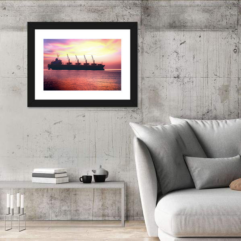 Sunset Cargo Ship Silhouette Wall Art in a room, landscape