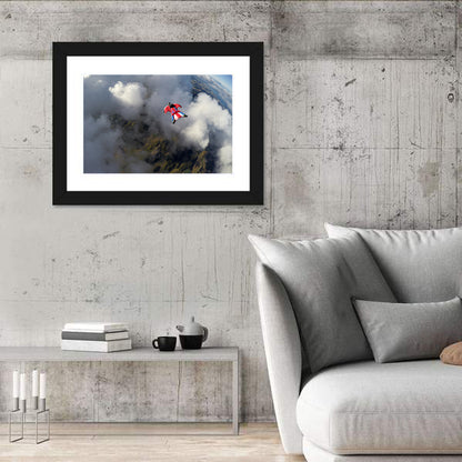 Red Wingsuit Skydiver Over Clouds Wall Art