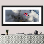 Red Wingsuit Skydiver Over Clouds Wall Art