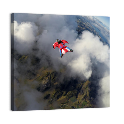 Red Wingsuit Skydiver Over Clouds Wall Art