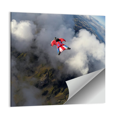 Red Wingsuit Skydiver Over Clouds Wall Art