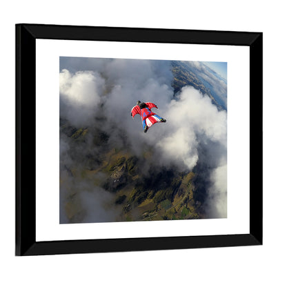 Red Wingsuit Skydiver Over Clouds Wall Art
