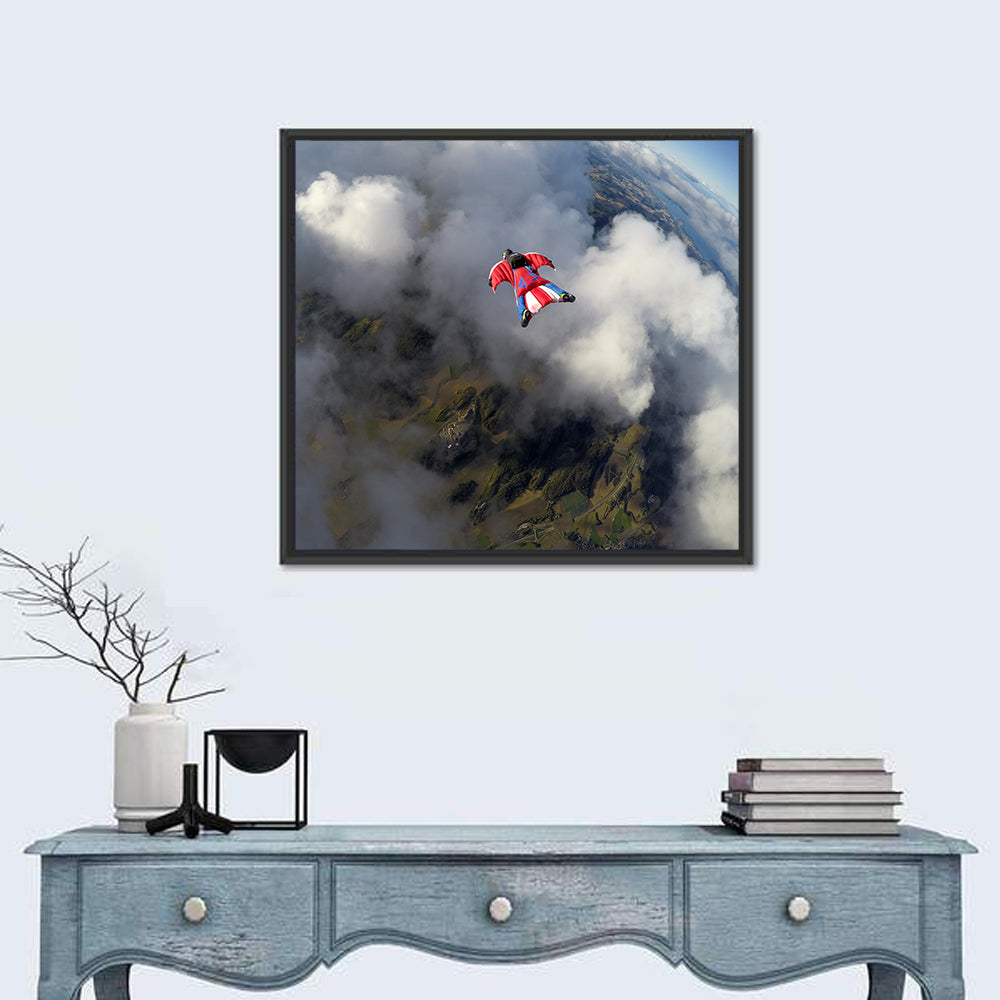 Red Wingsuit Skydiver Over Clouds Wall Art