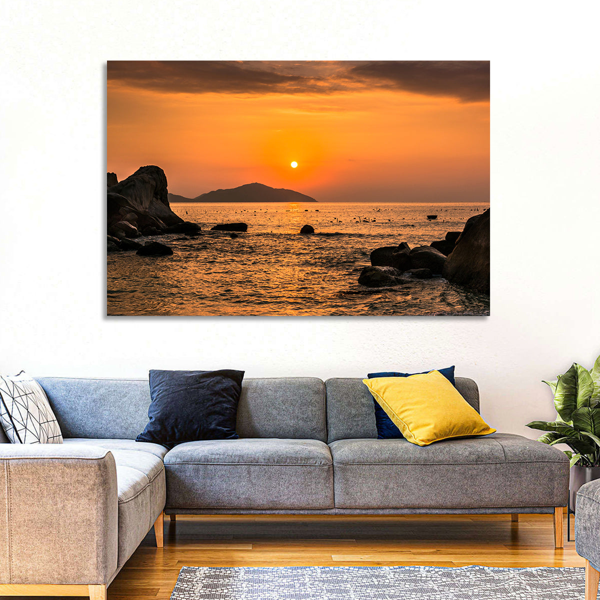 Orange Sunrise Over Rocky Coast Wall Art in a room, landscape