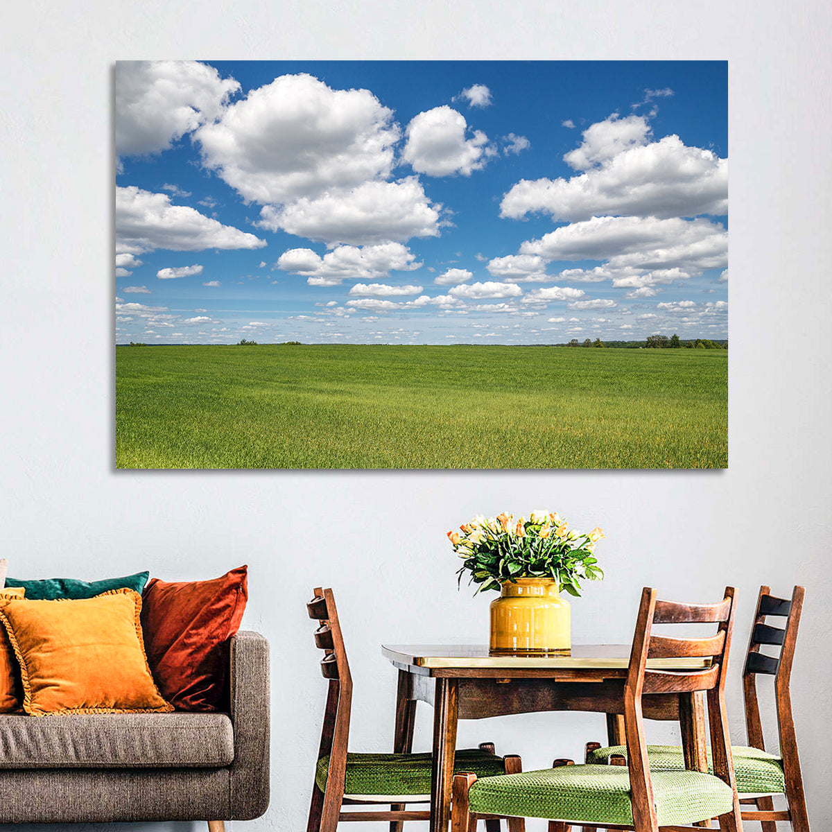 Cloud Filled Sky Over Meadow Wall Art in a room, landscape
