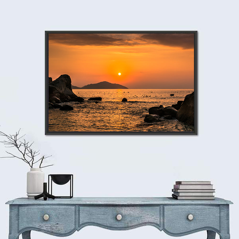Orange Sunrise Over Rocky Coast Wall Art in a room, landscape