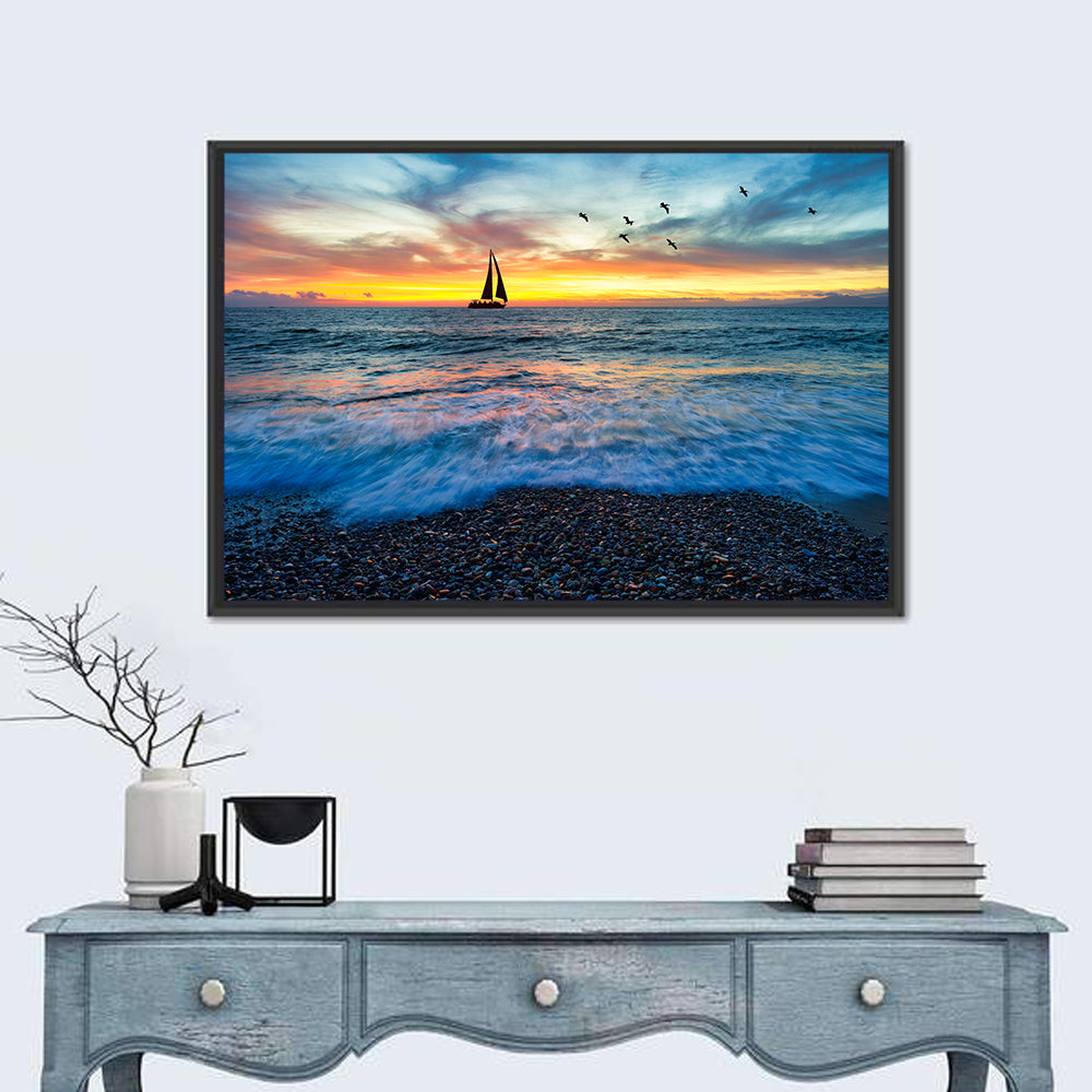 Sunset Sailboat Over Pebble Shore Wall Art in a room, landscape