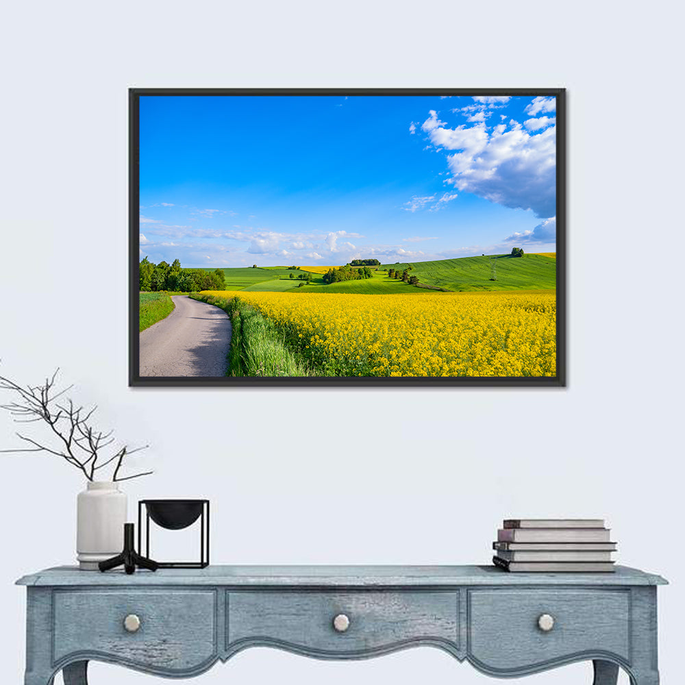 Rapeseed Field Road Under Blue Sky Wall Art in a room, landscape