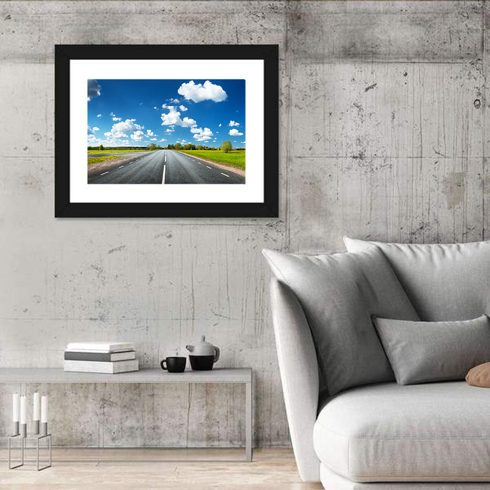Asphalt Road Through Meadow Wall Art in a room, landscape