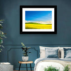 Rapeseed Field and Rolling Hills Under Blue Sky Wall Art