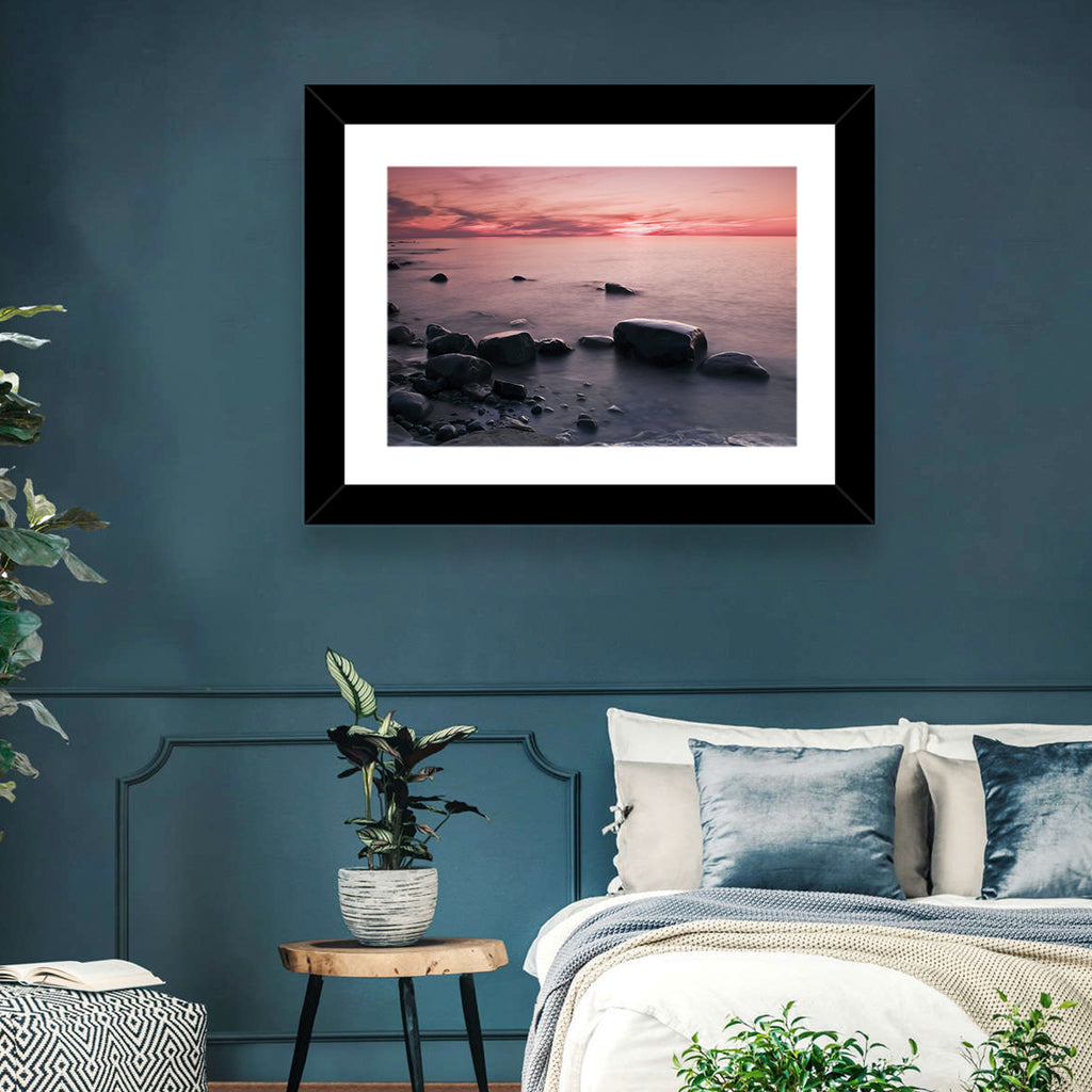 Pink Dusk Lakeshore with Silhouetted Rocks Wall Art