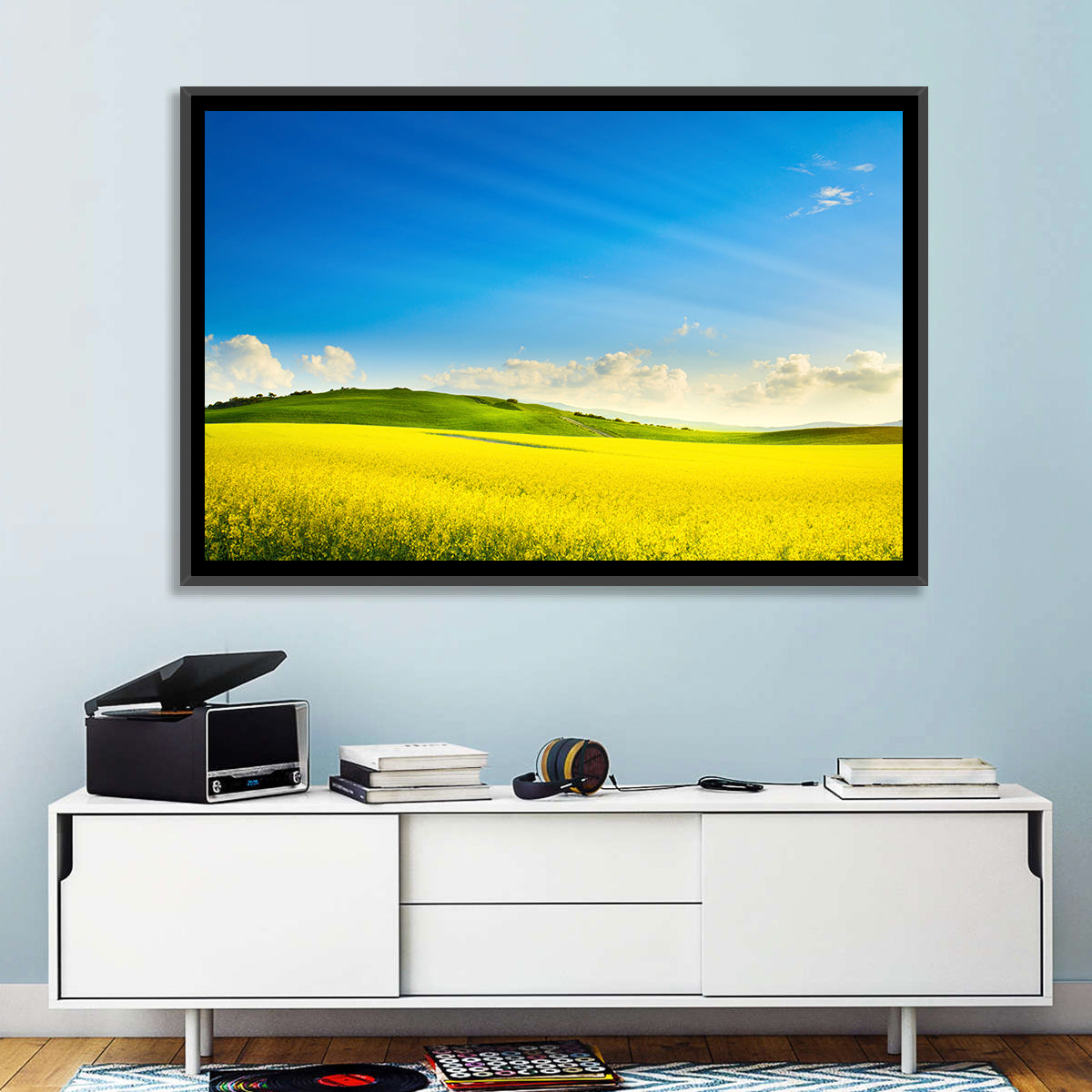 Rapeseed Field and Rolling Hills Under Blue Sky Wall Art in a room, landscape