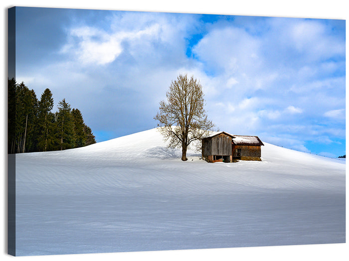 Rustic Barn on a Snowy Hill Wall Art as a canvas print