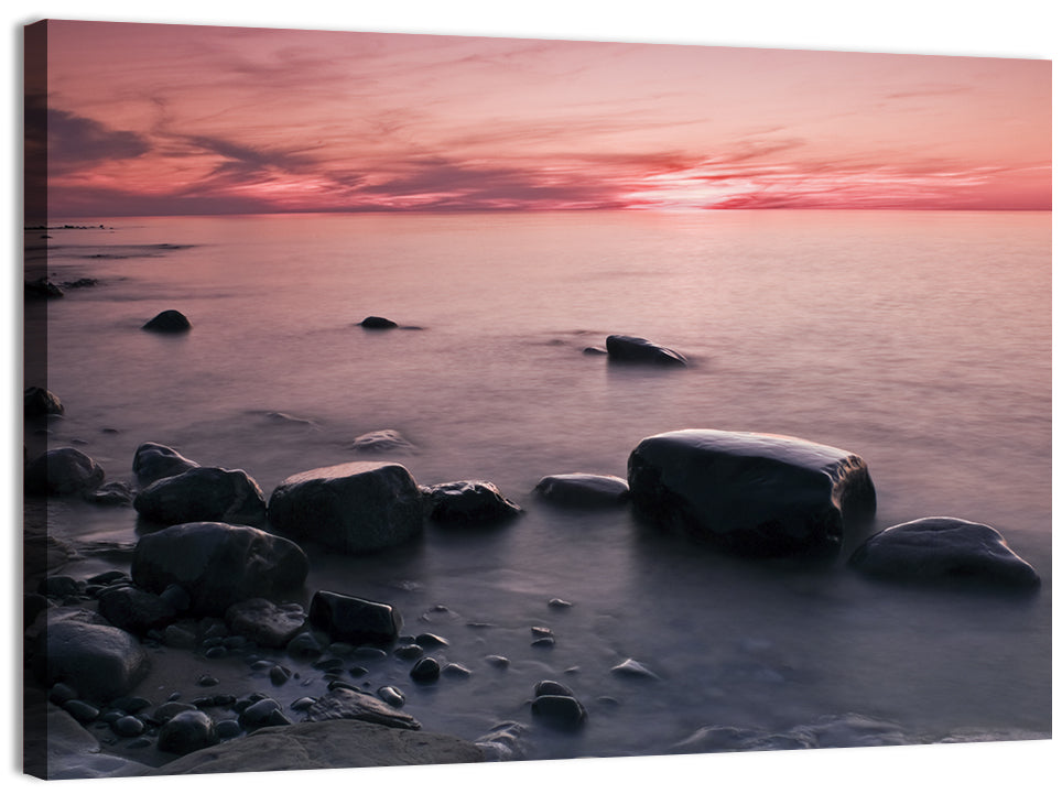 Pink Dusk Lakeshore with Silhouetted Rocks Wall Art