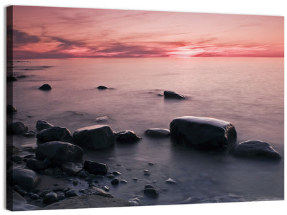 Pink Dusk Lakeshore with Silhouetted Rocks Wall Art