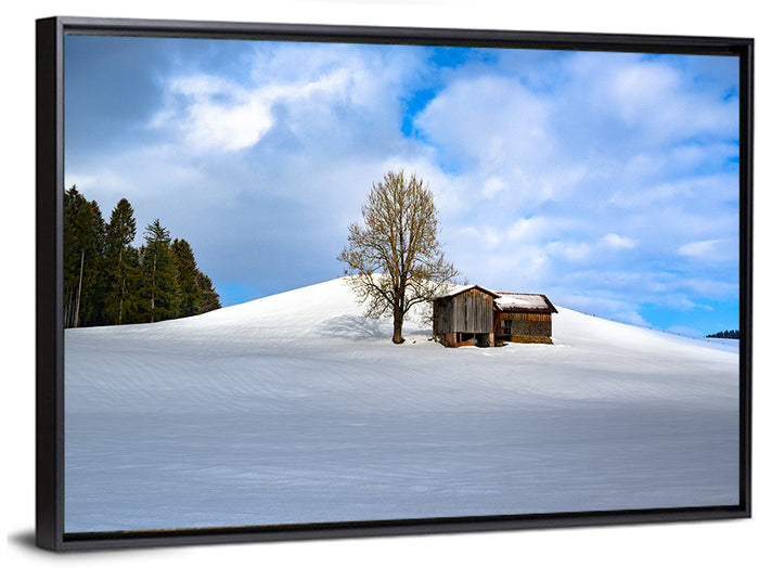 Rustic Barn on a Snowy Hill Wall Art as a framed canvas