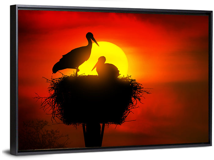 Storks in Nest at Sunset Wall Art as a framed canvas