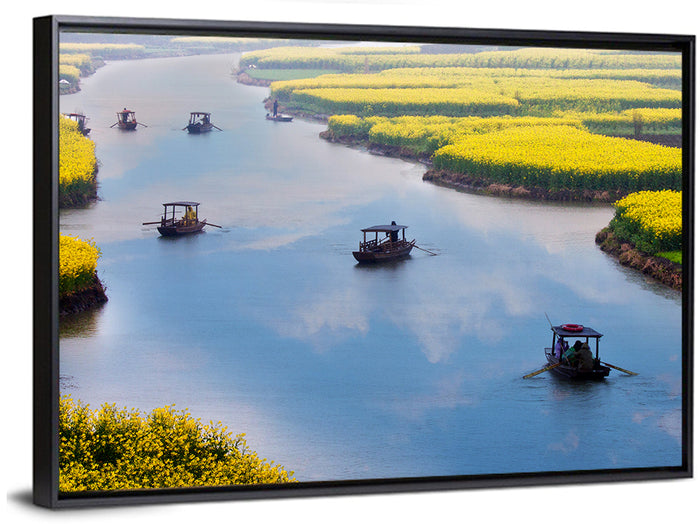Spring River Rowboats in Rapeseed Fields Wall Art as a framed canvas