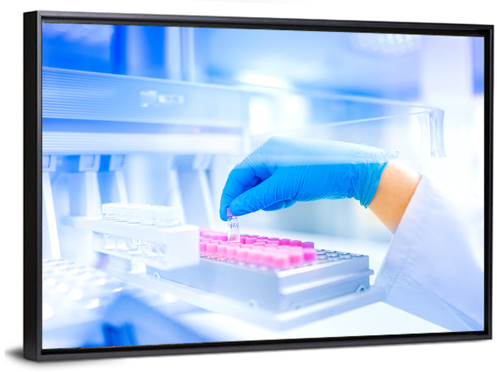 Gloved Hand with Vial and Pink-capped Tubes Wall Art as a framed canvas