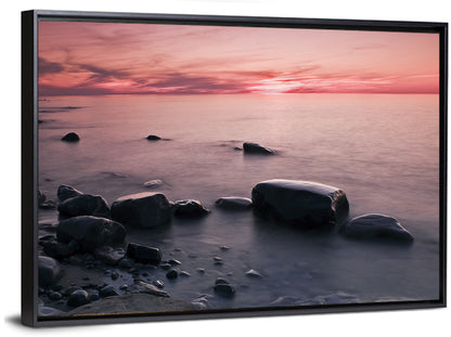 Pink Dusk Lakeshore with Silhouetted Rocks Wall Art