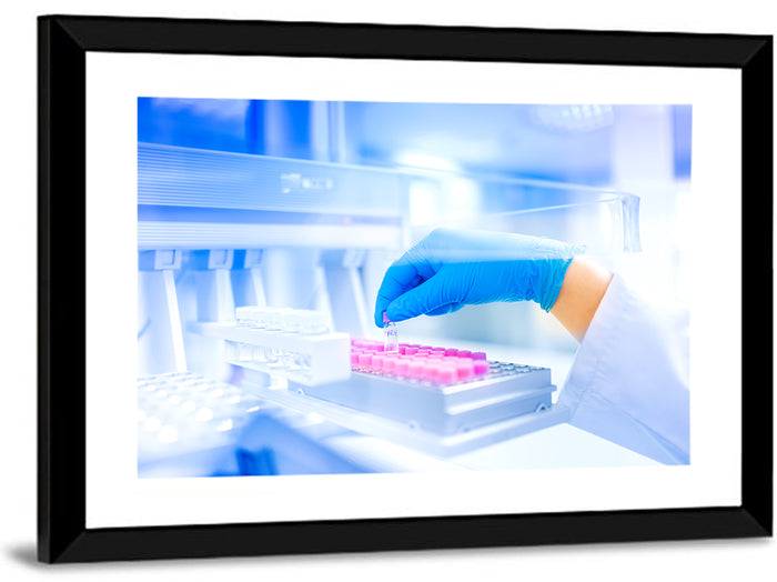 Gloved Hand with Vial and Pink-capped Tubes Wall Art as a framed print